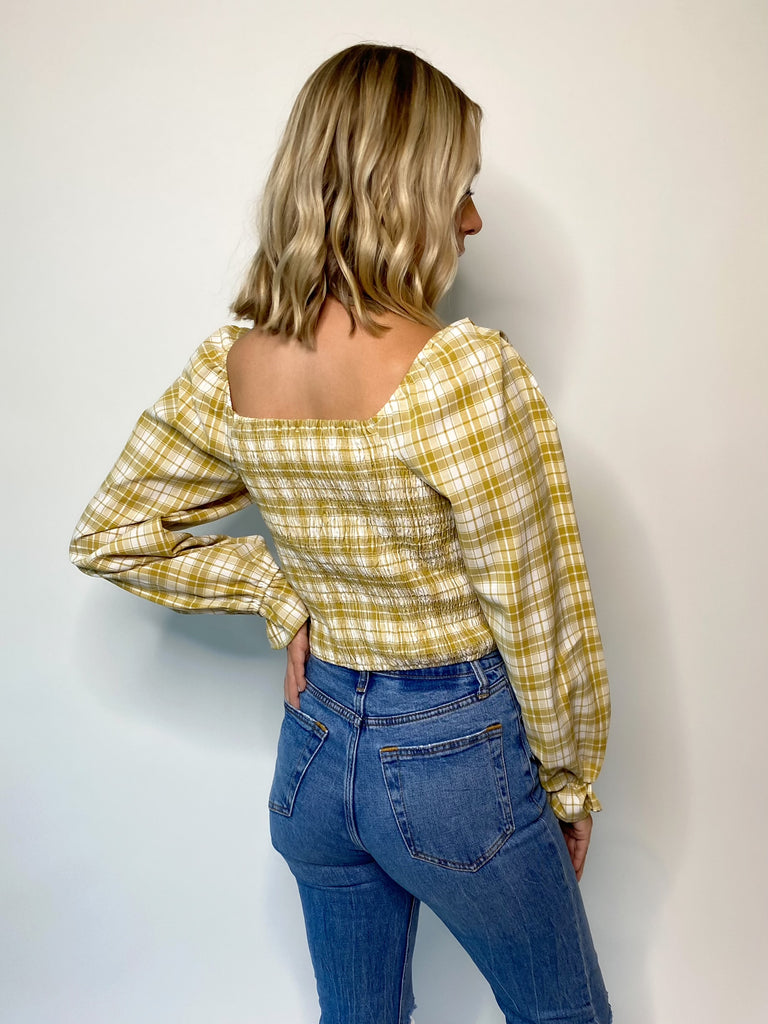 camel colored plaid print woven blouse with a square neck/back and smocked bodice 